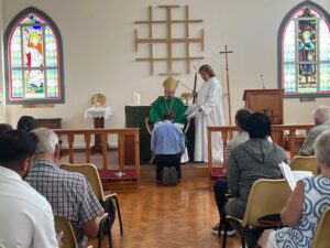 Bishop Sean confirming a young man at St Helena's Larnaka